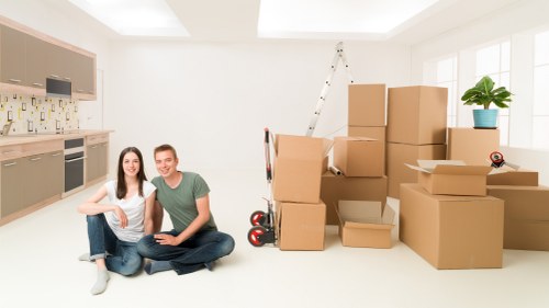 Moving crew loading boxes into a Kingston removal van